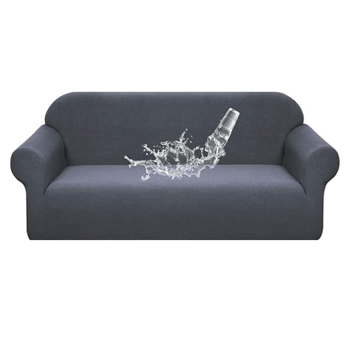 grey couch cover with a glass of water spilling to show effectiveness of the cover